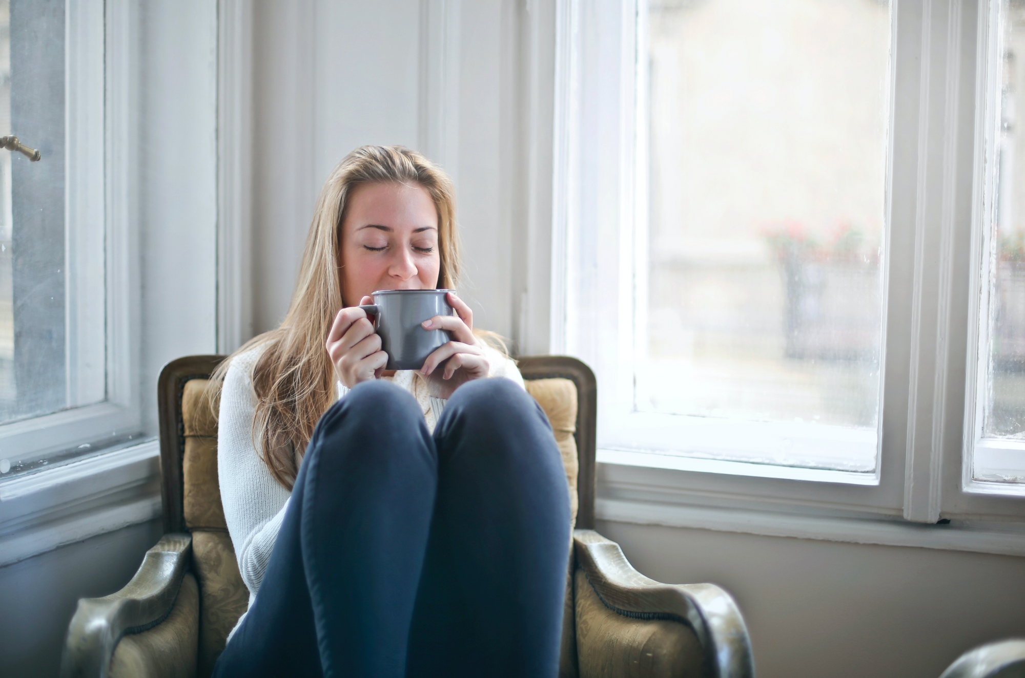 Woman looking relaxing sipping on a warm beverage