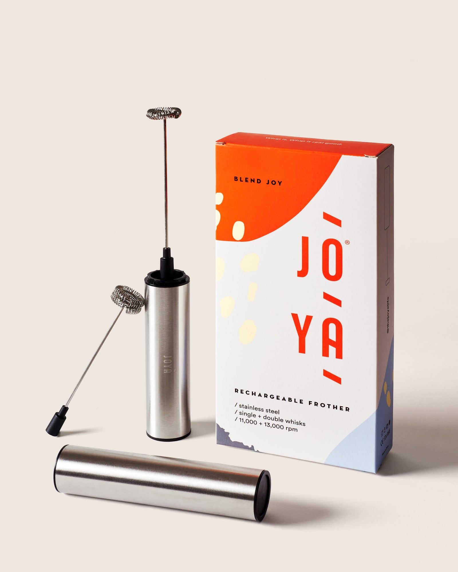 Handheld rechargeable frother standing beside its branded box