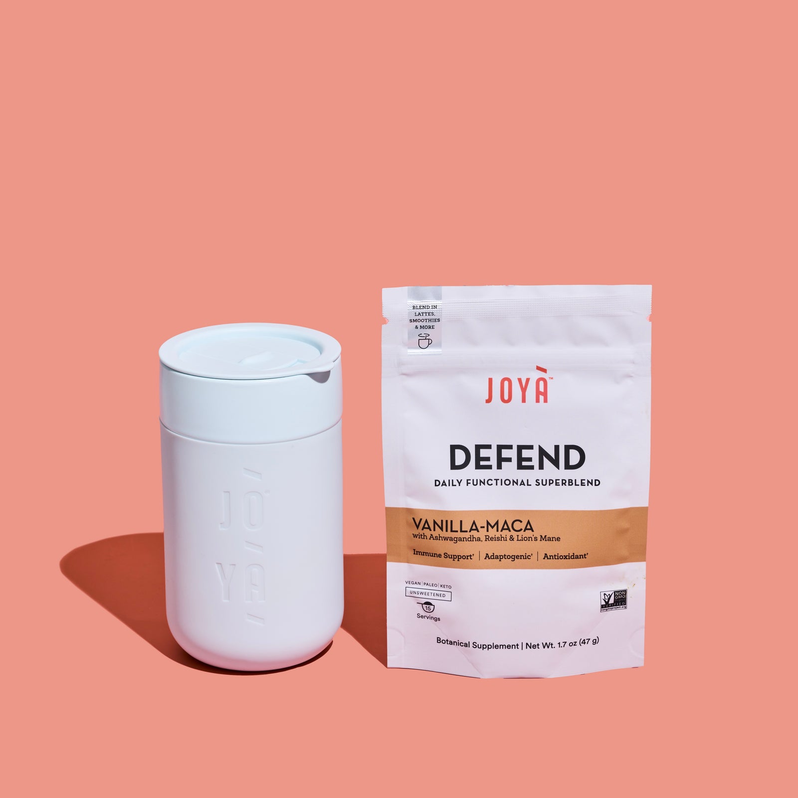 JOYÀ ceramin mug next to a pouch of Defend Superblend