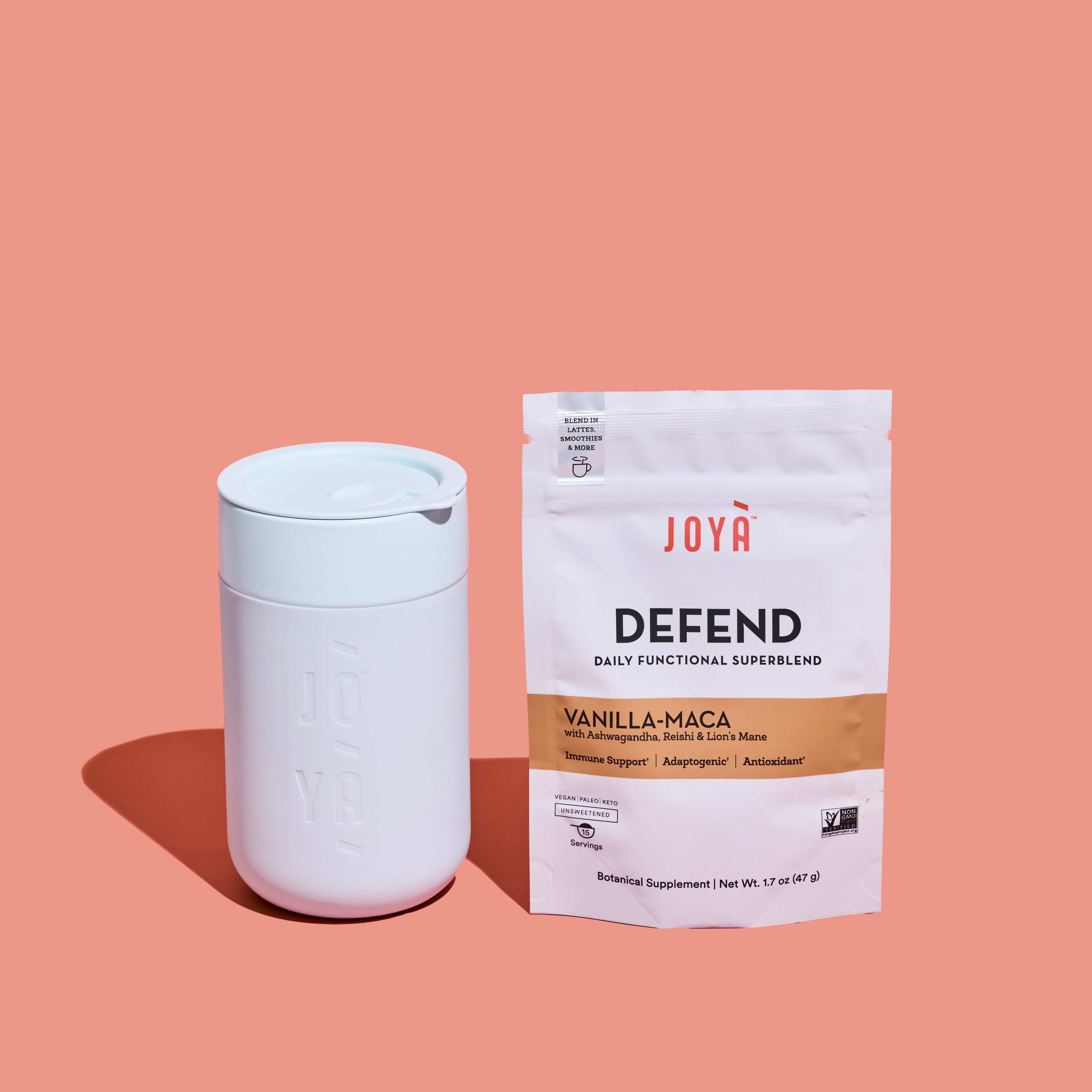 JOYÀ ceramin mug next to a pouch of Defend Superblend