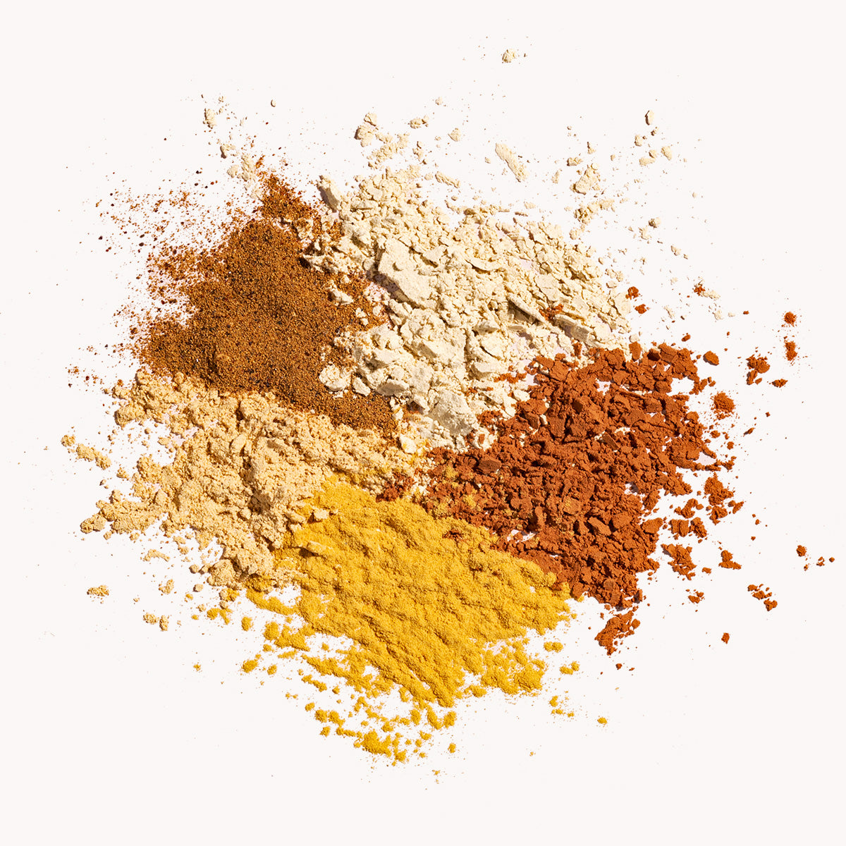 Turmeric, ashwagandha, maca and cacao powders on a white background