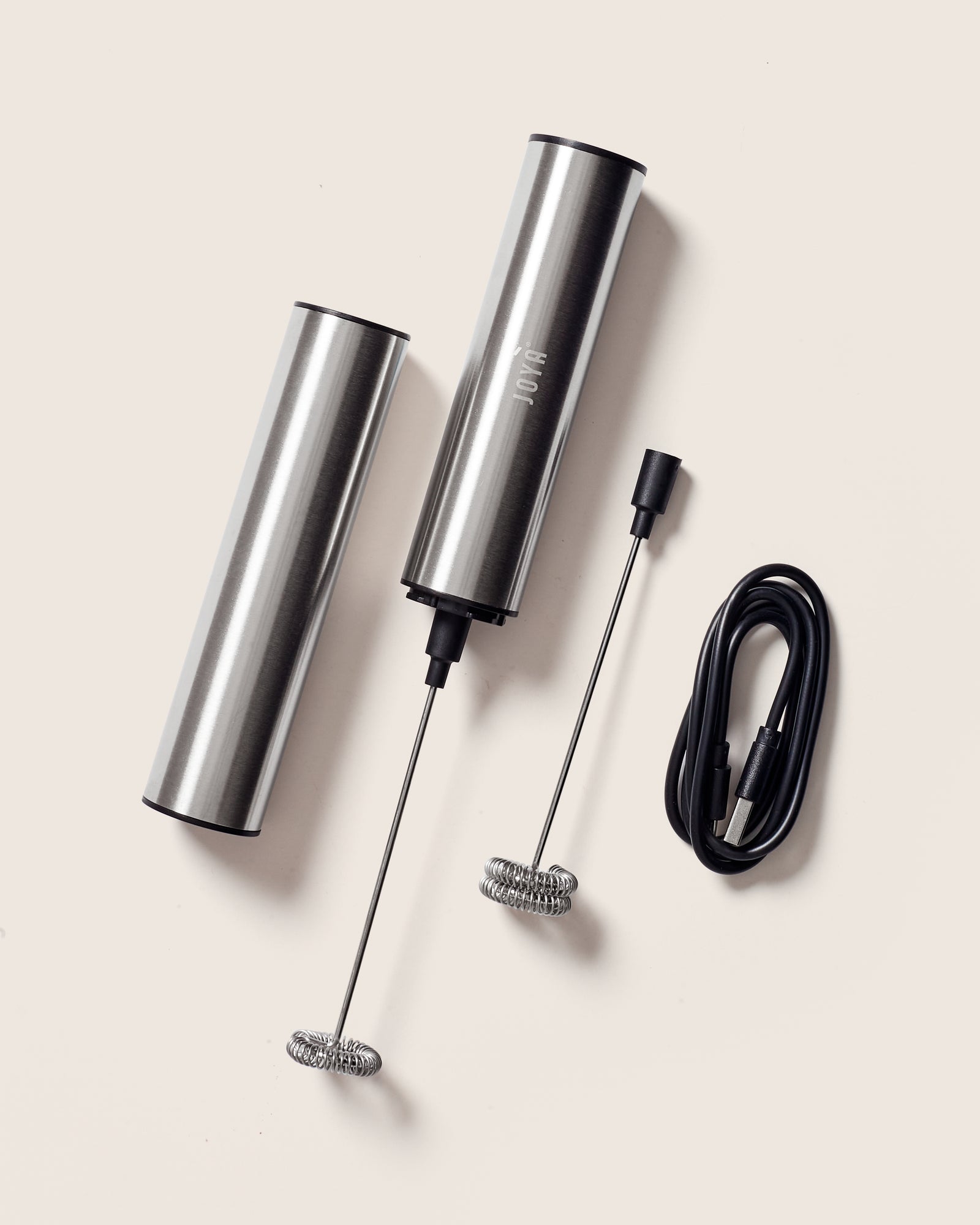 JOYÀ handheld rechargeable milk frother and blender with travel case and USB charging cord.