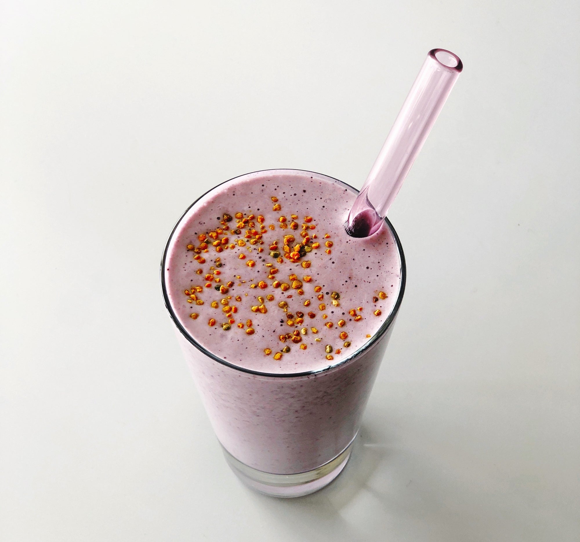 Image of a protein and berry post-workout smoothie topped with bee pollen