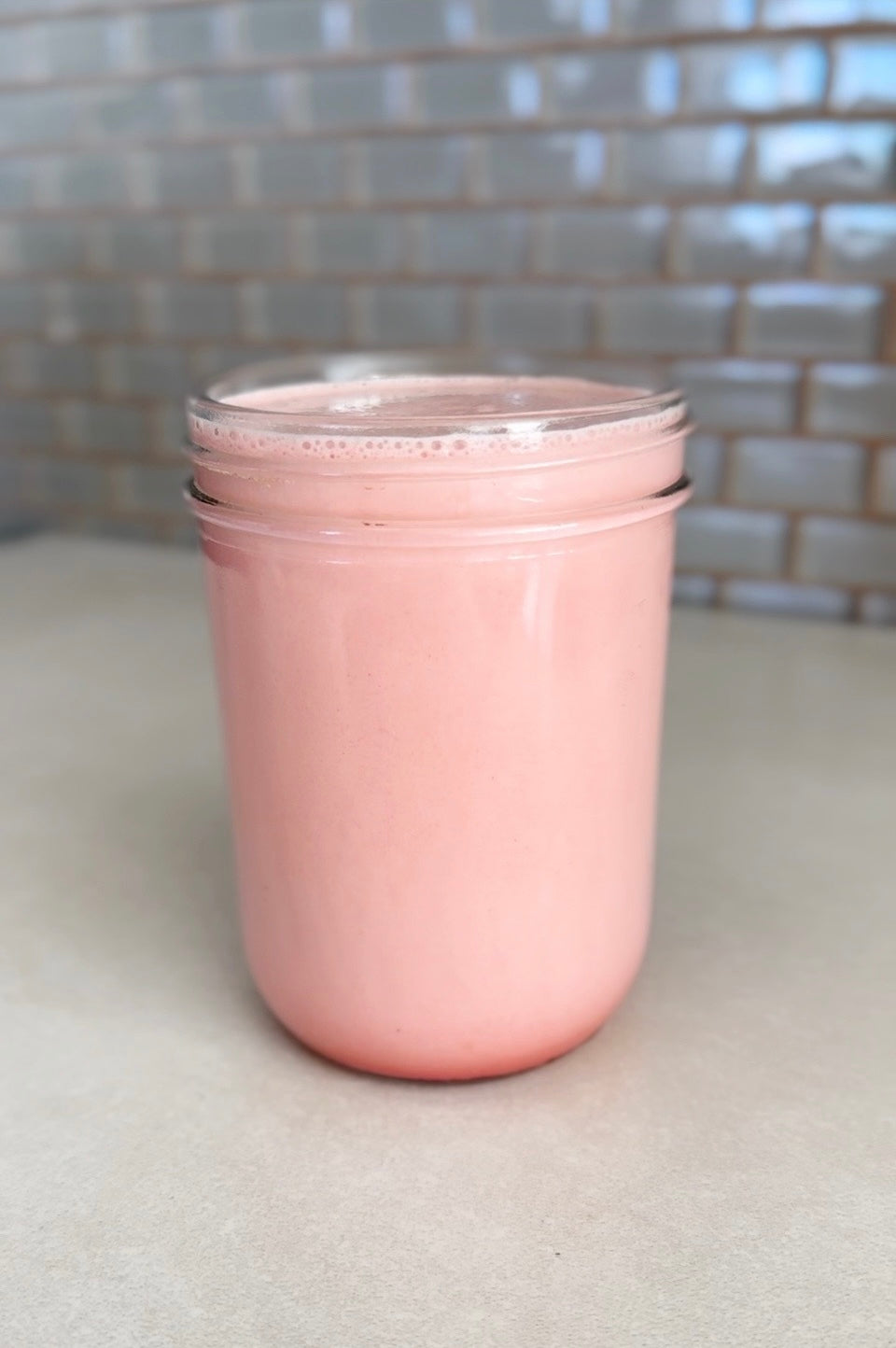 A cup of Berry-Rose Protein Shake with JOYÀ Defend Vanilla-Maca Superblend