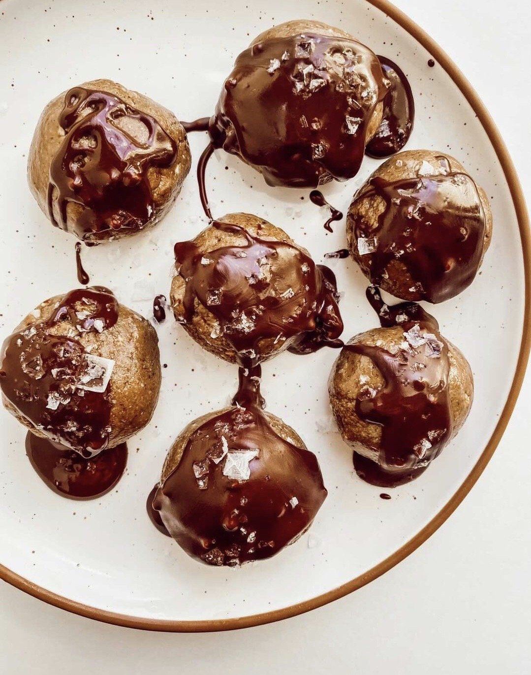 Overhead view of JOYA Chocolate Covered Orange Protein Balls on a plate