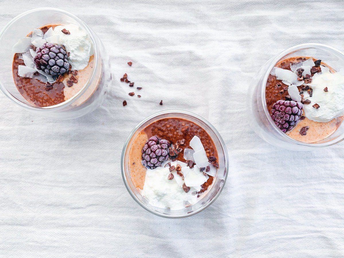 three cups of vegan chia pudding form above