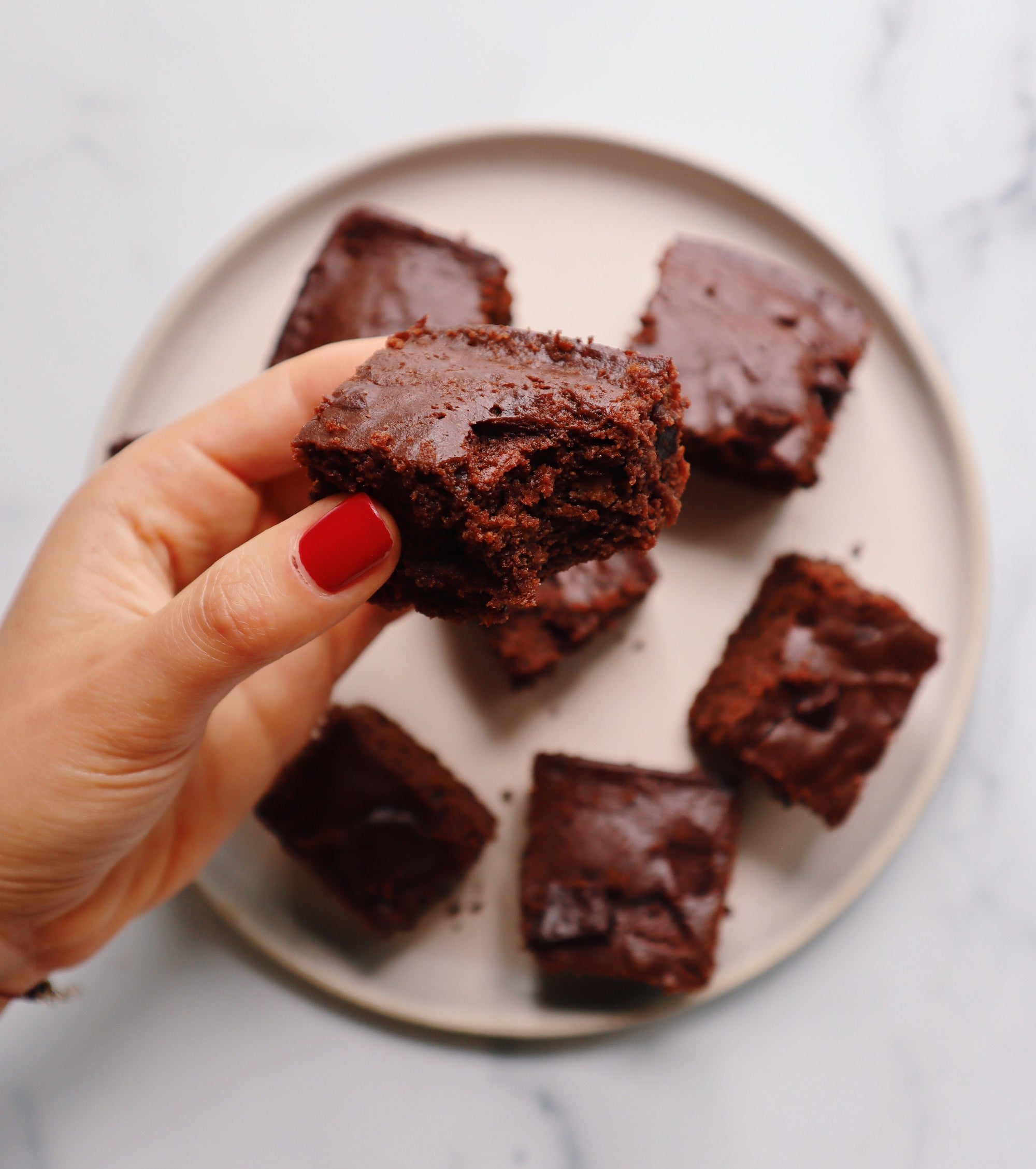 Plate full of paleo brownies featuring JOYA chocolate in recipe