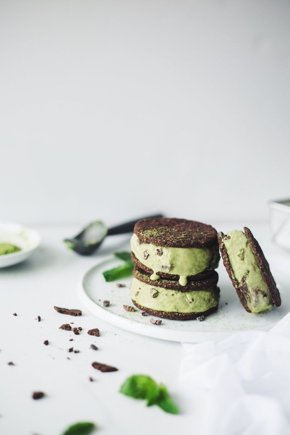 matcha mint chip ice cream sandwich on white plate with chocolate sprinkled