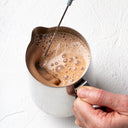 Blending a hot cacao elixir with a JOYÀ handheld rechargeable milk frother and blender.

        